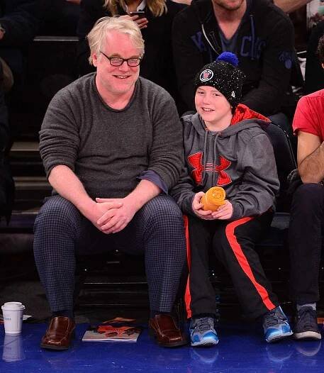 Phillip Seymour Hoffman and Cooper Alexander Hoffman attend the Oklahoma City Thunder vs New York Knicks game at Madison Square Garden on December 25, 2013 in New York City. 