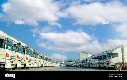 Fleet of trucks parked at parking lot yard of delivery company. Truck transport. Logistic industry. Freight transportation. Truck leasing. Commercial truck for delivering goods from warehouse. Cargo Stock Photo