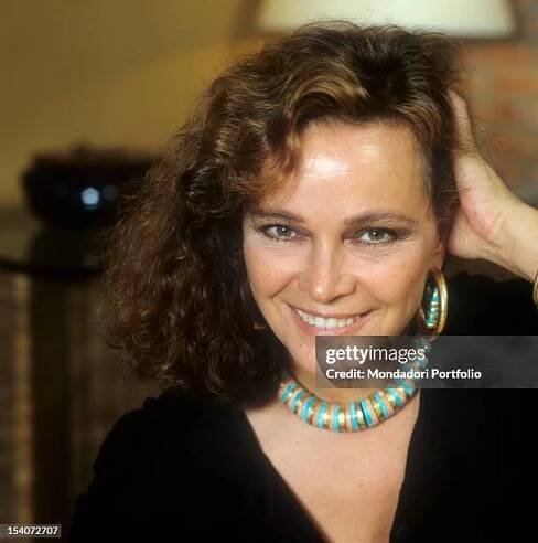 Portrait of Italian actress Laura Antonelli running her hand through her hair. 1989