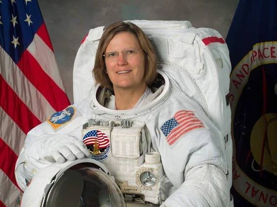 Dr. Kathryn D. Sullivan, a white female astronaut, poses formally in astronaut gear for her official portrait.
