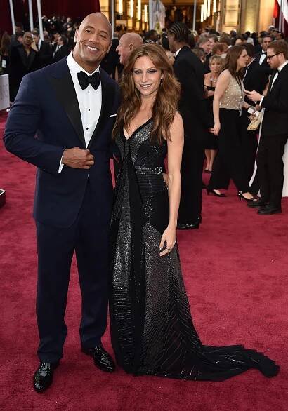 Actor Dwayne 'The Rock' Johnson (L) and Lauren Hashian pose on the red carpet for the 87th Oscars on February 22, 2015 in Hollywood, California. AFP PHOTO/ MLADEN ANTONOV (Photo credit should read MLADEN ANTONOV/AFP/Getty Images)