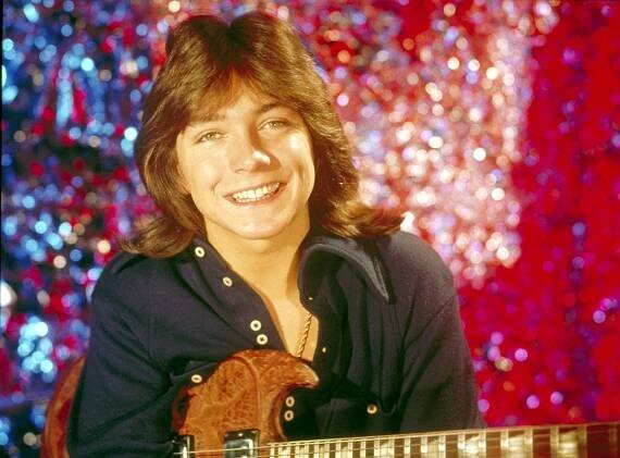 David Cassidy of The Partridge Family, holding a guitar.