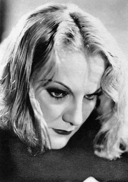 a black and white photo of a woman holding a cell phone