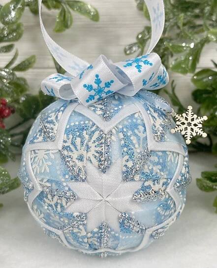 a blue and white ornament with snowflakes on it