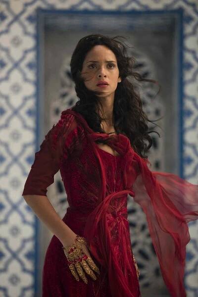 Adria Arjona wearing a red gown in a still from 'Emerald City'