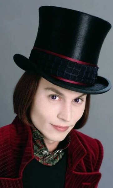 a man wearing a black top hat and red jacket