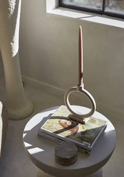 Table with coasters, magazine, and a candle