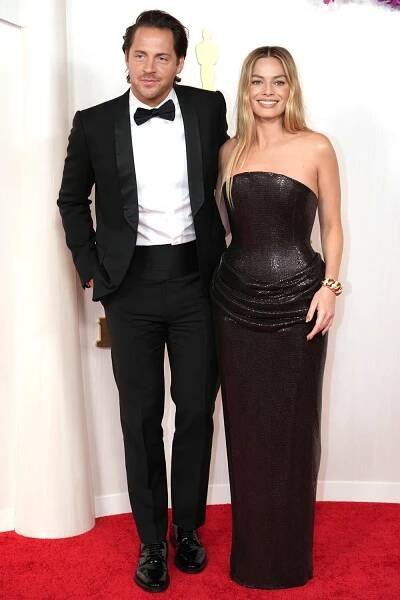 Tom Ackerley and Margot Robbie attend the 96th Annual Academy Awards on March 10, 2024 in Hollywood, California.
