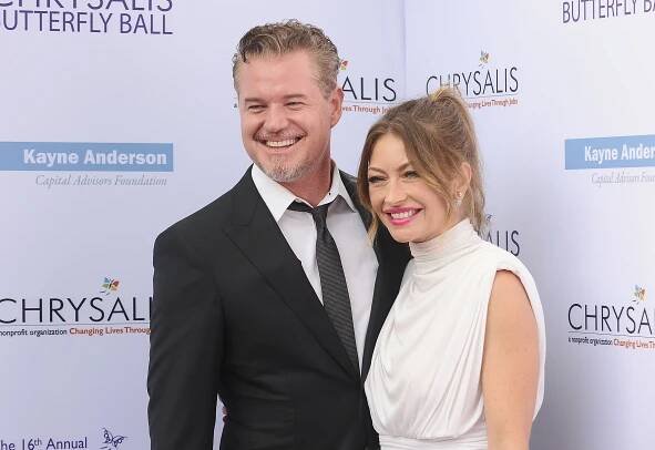 Eric Dane in a suit and Rebecca Gayheart in a sleeveless white dress