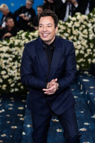 Jimmy Fallon in a blue blazer and dress pants.
