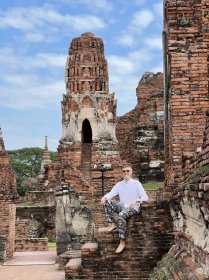 Nate Hake posing for a photo on a temple in Ayutthaya, Thailand