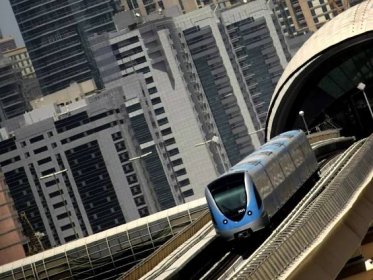 A metro train driving through Sheikh Zayed road in Dubai