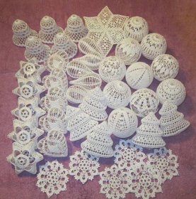 white crocheted ornaments are laid out on the floor