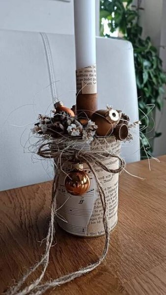 a candle that is sitting on top of a table with some kind of decoration in it