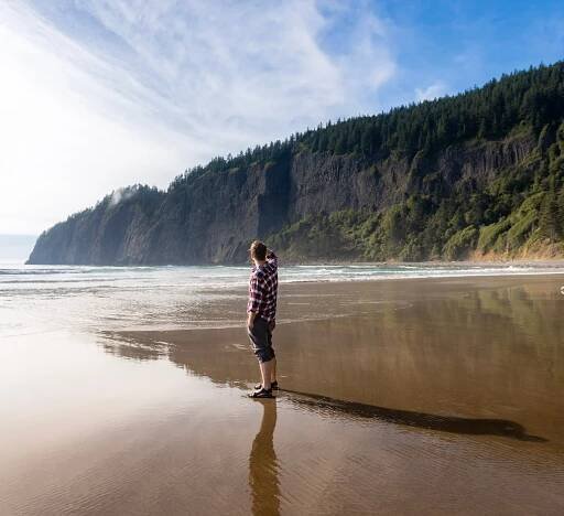 Man standing on the beach at Cape Lookout State Park along the Oregon Coast
