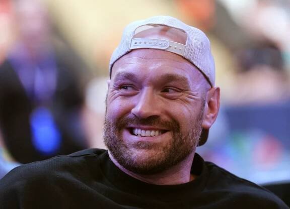 Tyson Fury smiling at Wembley Stadium.