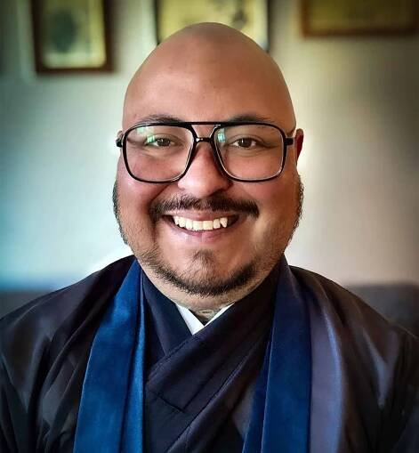 Participant Finn wearing glasses and smiling