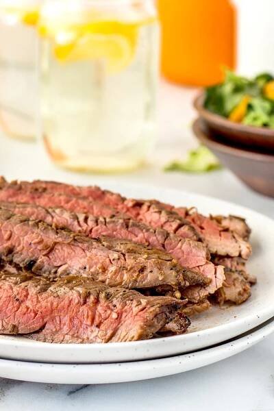 This Grilled Flank Steak done in a quick marinade and grilled over high heat simply melts in your month. It's perfect for a week night meal for the clan or a casual weekend dinner!