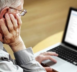 elderly person using a computer to gather information