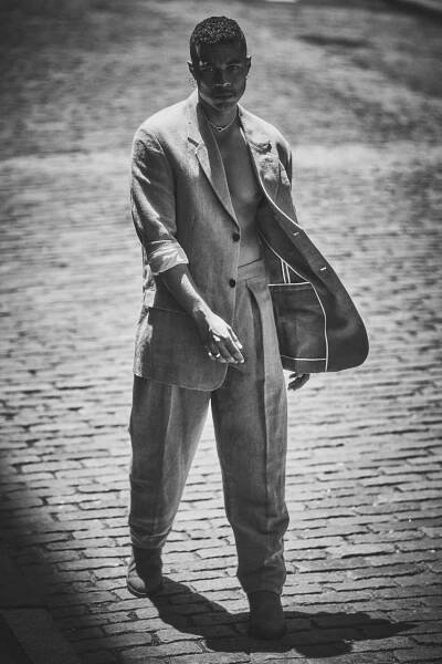 Ismael wears suit jacket and pants by THE ROW; boots by TECOVAS; necklace and ring by KLOTO; gold earrings and rings by SHIHARA.