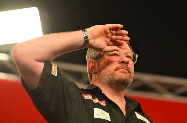 James Wade celebrates winning a quarter-final darts match.