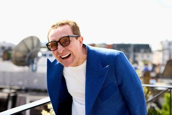 Eddie wears coat by Mark Powell, jeans by Applied Art Forms, sneakers by Grenson, eyewear by Gentle Monster.