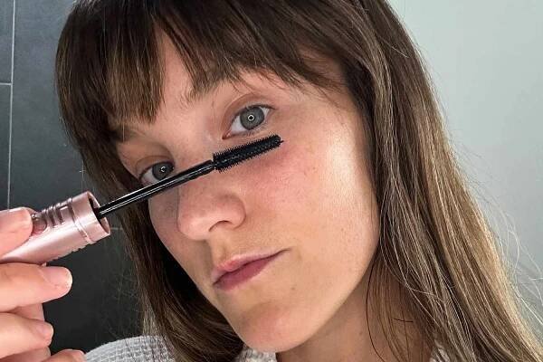 A person applying the Maybelline Lash Sensational Sky High Waterproof Mascara to their bottom lash