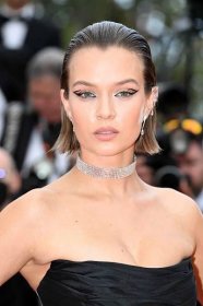 Josephine Skriver with brushed-back bixie haircut and diamond choker attends the screening of "Top Gun: Maverick" during the 75th annual Cannes film festival