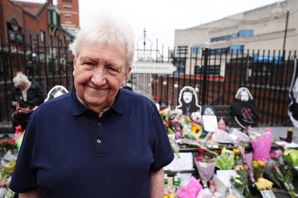 Black Sabbath's first manager Jim Simpson views the floral tributes left on the Black Sabbath Bridge bench on Broad Street in Birmingham, following the death of Black Sabbath frontman Ozzy Osbourne aged 76. Picture date: Wednesday July 23, 2025. PA Photo. Photo credit should read: Jacob King/PA Wire