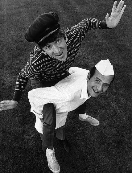 Bob Denver riding piggyback on the back of Herb Edelman in an outdoor promotional photo for their television series, 'The Good Guys' in 1968