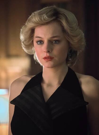 a woman with blonde hair wearing a black dress