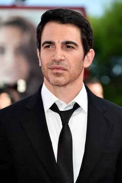 a man in a black suit and white shirt