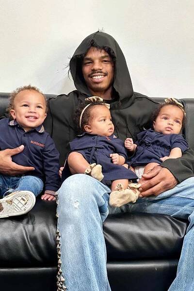 YG Marley smiles with his three children.