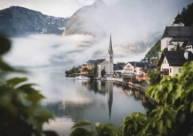 View of the Hallstatt World Heritage Site with the surrounding misty mountain and lake landscape in Austria
