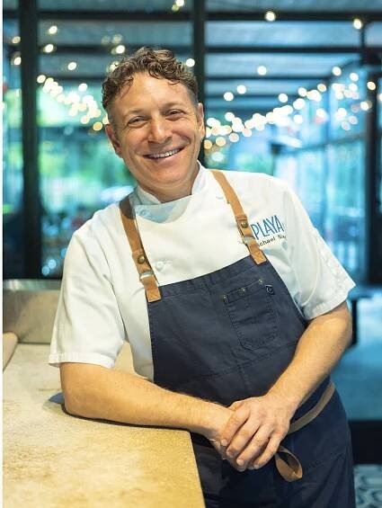 Chef Michael Siegel of Mill Valley's Corner Bar restaurant in chef whites and a blue apron