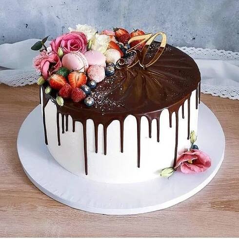 a cake with chocolate icing and flowers on top