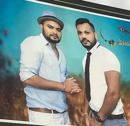 Photo of two men posing together.