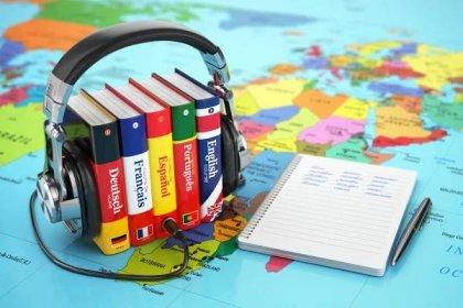 Learning languages online. Audiobooks concept. Books and headpho Stock Photo by ©maxxyustas 90027426