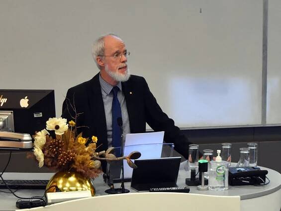 Tom Griffiths standing at a lectern.