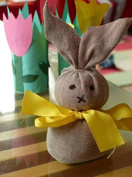 a stuffed bunny sitting on top of a wooden table