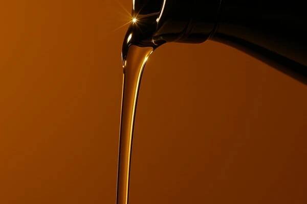 Olive oil pouring out of an amber bottle