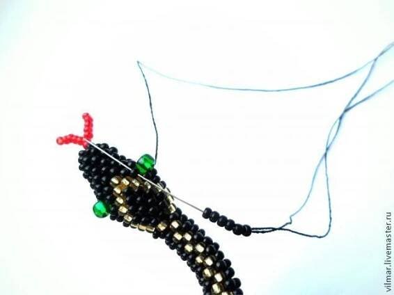 a beaded object is hanging on a string