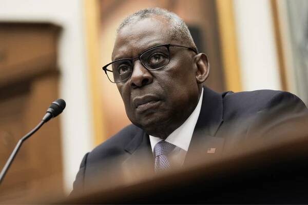 Lloyd Austin, in a dark blue suit, looks at members of the House Armed Services Committee during a hearing on Thursday. 