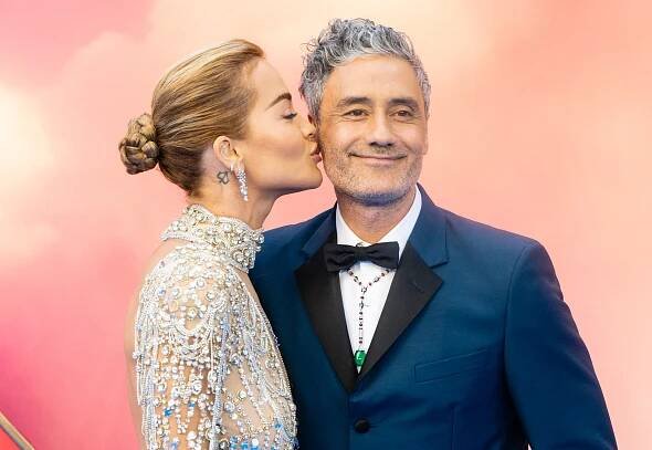Rita Ora kissing Taika Waititi on the cheek at a film screening.