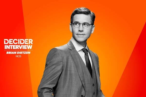 Brian Dietzen in black and white on a bright orange background