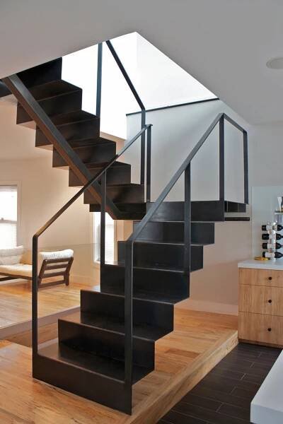 there is a black stair case in the living room