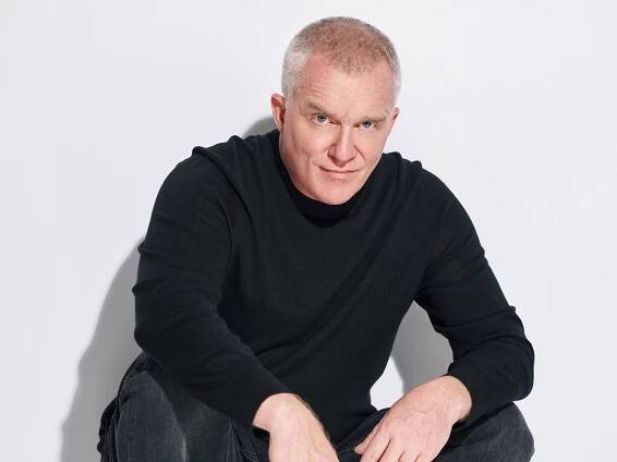 Anthony Michael Hall in a black sweater and pants with white shoes