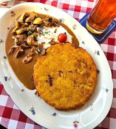 Rosti on a plate served with Zurich style veal.
