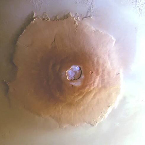 Image of Mars volcano Olympus Mons, showing frost in white-blue on top. Captured by the Mars Express orbiter. Credit: ESA/DLR/FU Berlin