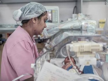Neonatal Care - Neonatal care female hospital staff member in a neonatal care